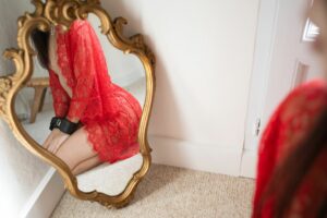 Femme en kimono de dentelle rouge, devant un miroir